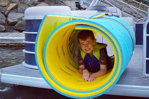 Small boy enjoying a water toy on the docs at Danvers Marina.