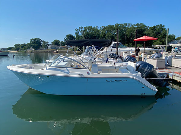 The motorboat is a Model 220DC, and the boat's name is My Turn.