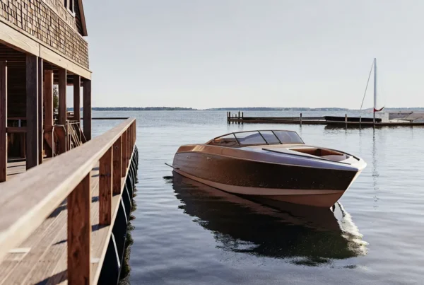 Modern speed boat powering across New England harbor waters on a sunny day