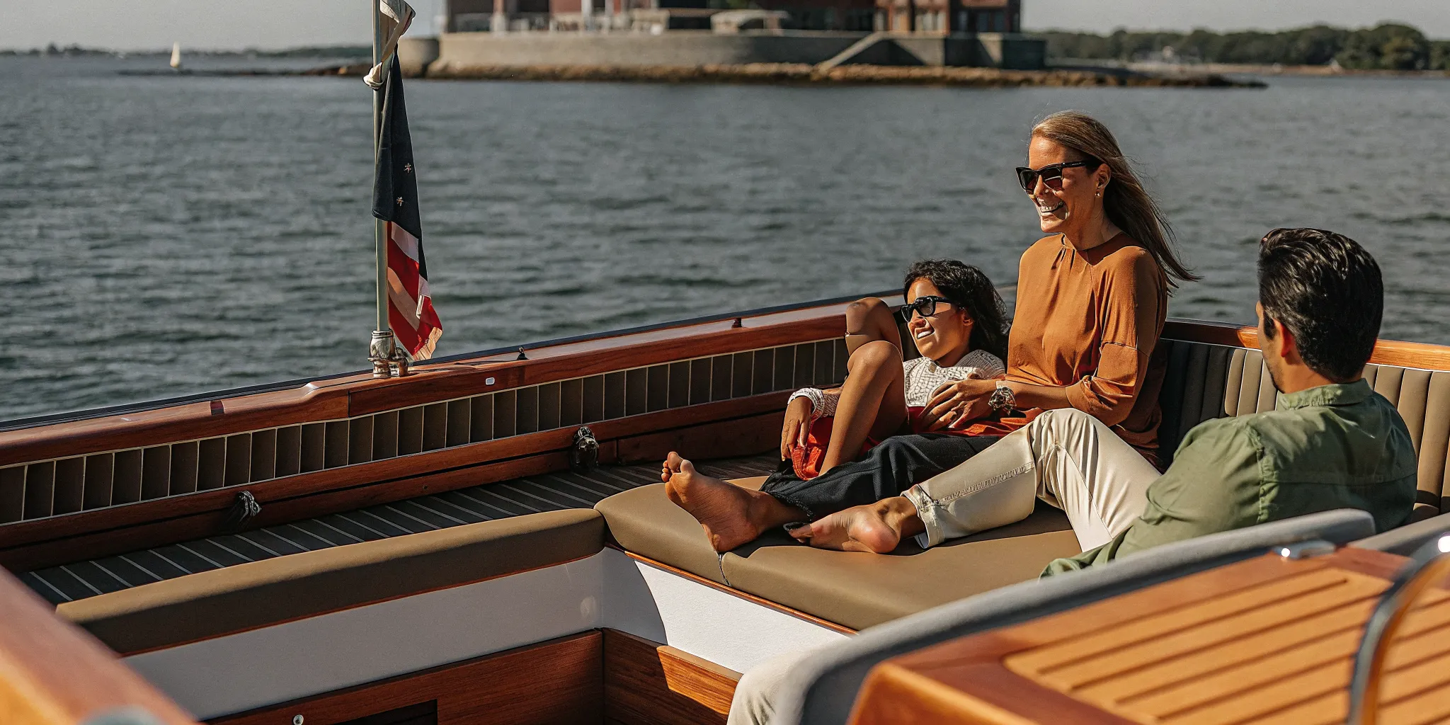 Family enjoying a sunny day on a modern boat in Boston Harbor