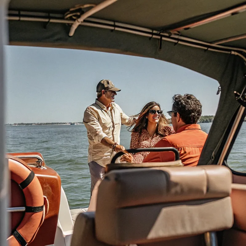 Family enjoying a sunny day boating on Boston Harbor with Massachusetts coastline in the background