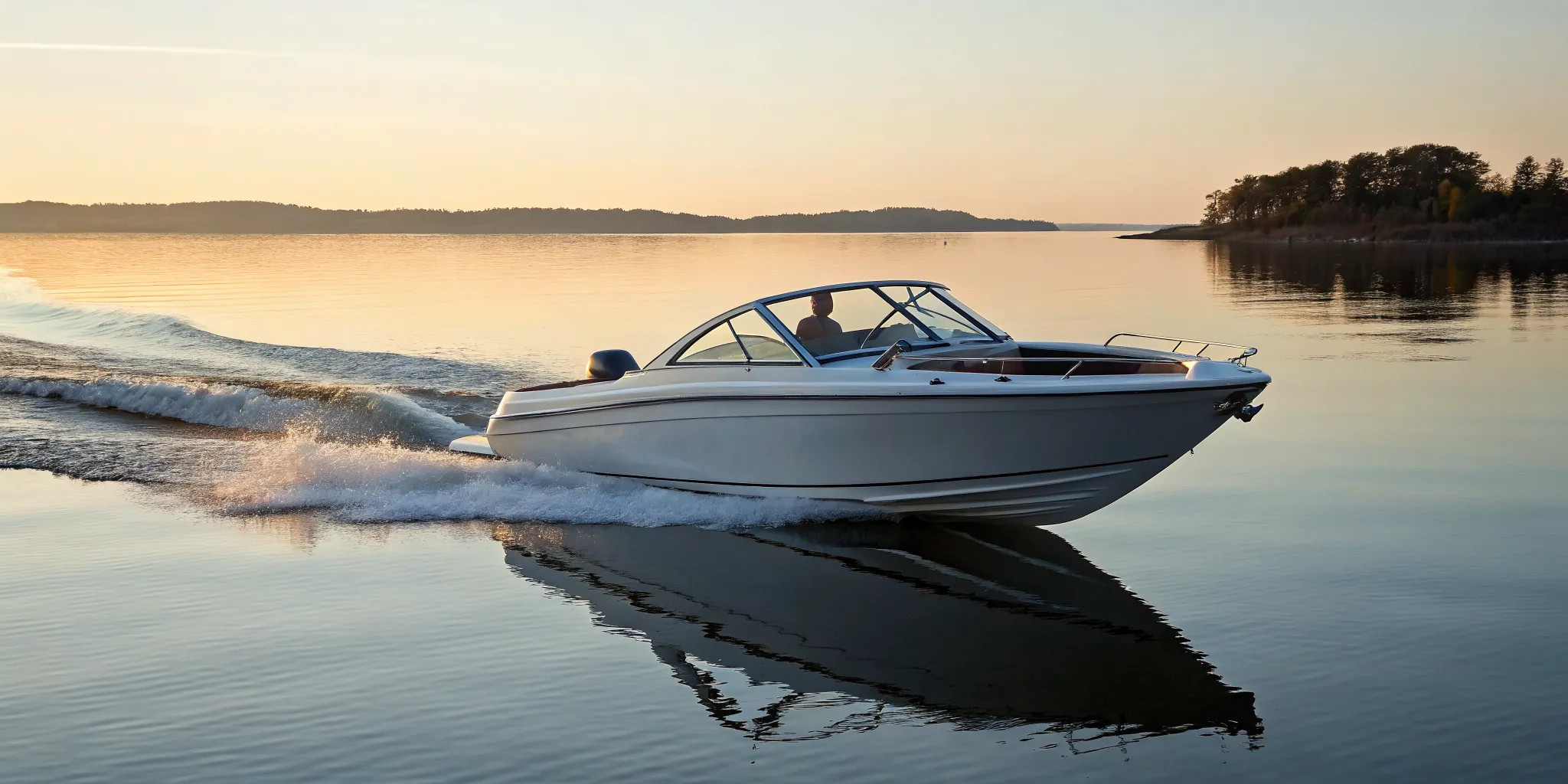 A ski boat on the water creating a wake for water sports.